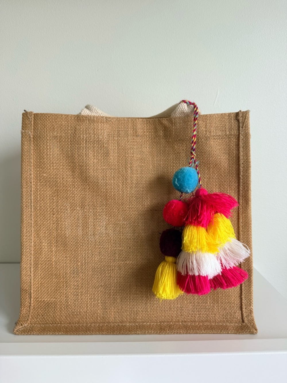 Jute Bag with pom pom multi color charm